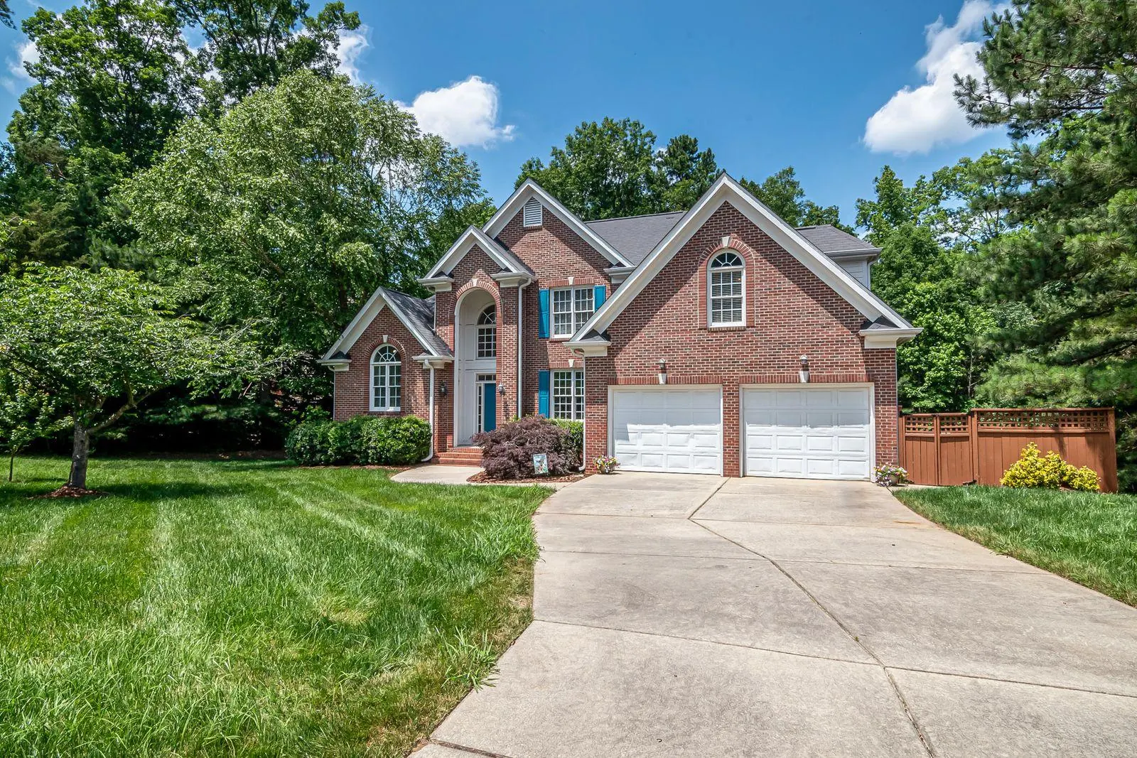 Brick suburban home with a shingle roof